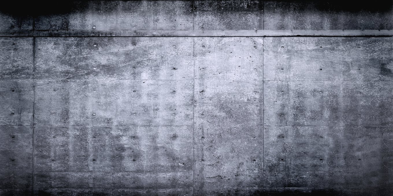 An empty concrete corridor lit from above